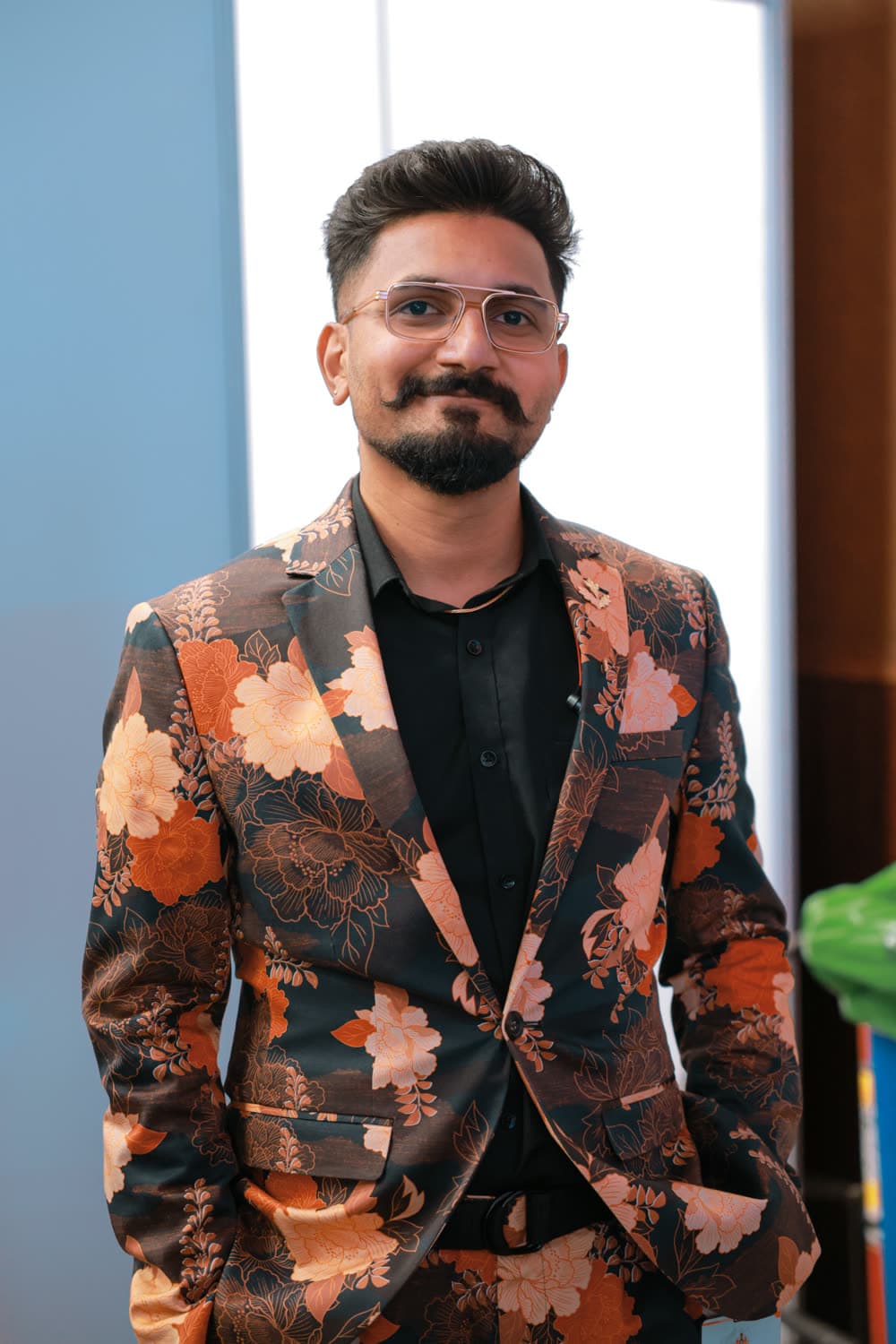Editorial portrait — floral brocade blazer, soft daylight backdrop